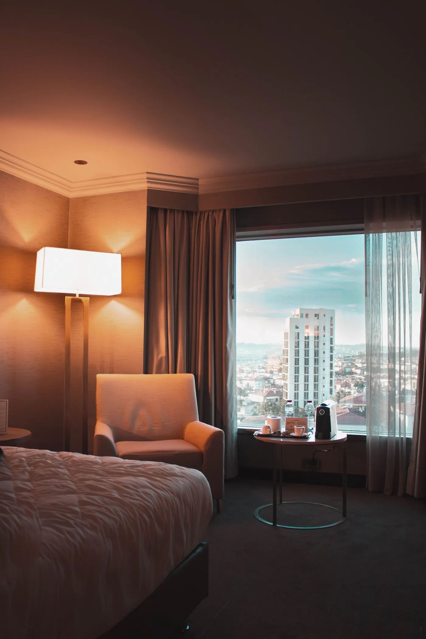 A hotel room with a city view.