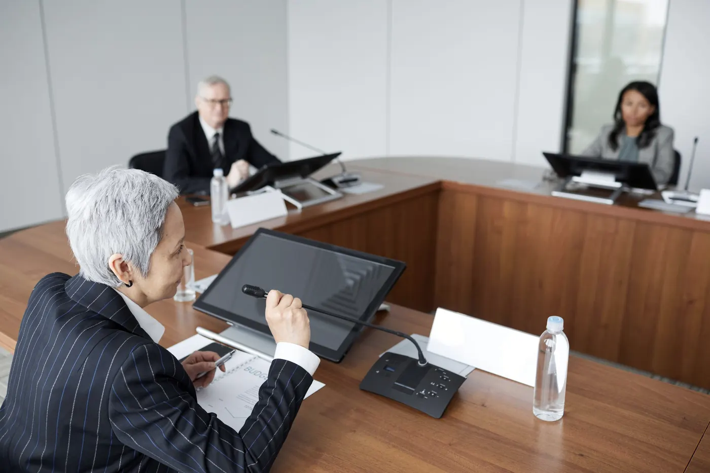 Executives in discussion across a conference table.